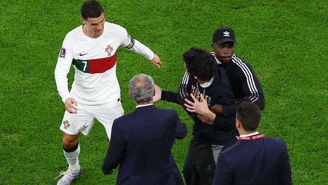 Usai laga Maroko vs Portugal di Piala Dunia 2022, Cristiano Ronaldo terlihat mendorong fans yang menerobos masuk lapangan.